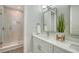 Contemporary bathroom featuring double vanity, marble counter, and a glass shower at 4322 Marina View Way, Cortez, FL 34215