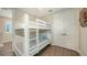 Charming bedroom with a bunk bed, hardwood floors, and a closet behind double doors at 4322 Marina View Way, Cortez, FL 34215