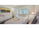 Cozy bedroom featuring a TV and a plush bed near a bathroom and a window at 4322 Marina View Way, Cortez, FL 34215