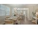 Dining area with a wooden table, seating for six, and views into the kitchen and living area at 4322 Marina View Way, Cortez, FL 34215