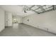 Spacious garage with clean, neutral paint and epoxy floors with an access to the patio at 4322 Marina View Way, Cortez, FL 34215