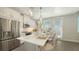 Bright kitchen featuring white cabinets, stainless steel appliances, and a marble-top island with seating at 4322 Marina View Way, Cortez, FL 34215