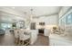 Airy kitchen with stainless steel appliances, white cabinets, and an open concept layout to the living area at 4322 Marina View Way, Cortez, FL 34215