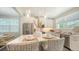 Bright kitchen featuring white cabinets, stainless steel appliances, and a marble-top island with seating at 4322 Marina View Way, Cortez, FL 34215