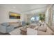 Relaxing living room with a large sectional, sliding glass doors, and beachy decor providing a serene feel at 4322 Marina View Way, Cortez, FL 34215