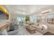 Sunlit living room featuring a large sectional sofa, sliding glass doors to a patio, and neutral decor at 4322 Marina View Way, Cortez, FL 34215