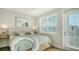 Cozy main bedroom with a beach-themed decor, a plush bed, and a decorative bench at 4322 Marina View Way, Cortez, FL 34215