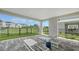 Inviting covered patio with outdoor lounge chairs overlooking a green space and neighborhood view at 4322 Marina View Way, Cortez, FL 34215
