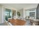 Inviting outdoor space with a dining table, cozy seating, and sliding glass doors to interior at 4322 Marina View Way, Cortez, FL 34215