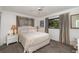 Bright bedroom with neutral walls, carpet flooring, and a large window with natural light at 4353 Indian Point Trl, Sarasota, FL 34238
