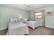 Cozy bedroom with two twin beds, carpet flooring, and ample natural light from the window at 4353 Indian Point Trl, Sarasota, FL 34238