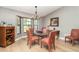 Elegant dining room featuring a glass table, plush seating, and a bay window with natural light at 4353 Indian Point Trl, Sarasota, FL 34238