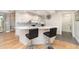 Modern kitchen features a central island with seating, stainless steel appliances, and sleek countertops at 4353 Indian Point Trl, Sarasota, FL 34238