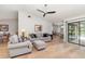 Bright living room with hardwood floors, comfortable seating, and sliding glass doors to an outdoor pool at 4353 Indian Point Trl, Sarasota, FL 34238