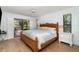 The main bedroom with wood flooring and sliding door access to screened patio at 4353 Indian Point Trl, Sarasota, FL 34238