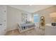 Cozy bedroom with a twin bed, a window for natural light, and a decorative ladder and side table at 4425 Boxelder Avenue, Parrish, FL 34219