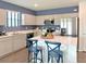Well-equipped kitchen with stainless steel appliances, a center island with bar seating, and wood-look floors at 4425 Boxelder Avenue, Parrish, FL 34219