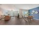 Open-concept living and dining area featuring modern decor, wood floors, and bright natural light at 4425 Boxelder Avenue, Parrish, FL 34219