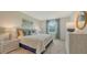 Serene bedroom with a plush bed, soft blue accents, and a large window providing natural light at 4425 Boxelder Avenue, Parrish, FL 34219