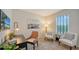 Bright office space with a desk, stylish chairs, a large window, and decor that creates a relaxing work environment at 4425 Boxelder Avenue, Parrish, FL 34219