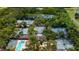 Aerial view of several tennis courts, clubhouse, and a pool surrounded by lush green trees at 4511 Windsor Park, Sarasota, FL 34235