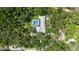 Aerial view of the property showcasing lush landscaping and a screened-in pool at 4511 Windsor Park, Sarasota, FL 34235