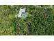 An aerial view of a home with a screened-in pool nestled among lush greenery and mature trees at 4511 Windsor Park, Sarasota, FL 34235