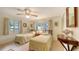 A comfortable bedroom illuminated by natural light featuring two beds and a ceiling fan at 4511 Windsor Park, Sarasota, FL 34235