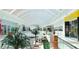 Bright mall interior with skylight, shops, tropical plants, seating and stylish architectural design at 4511 Windsor Park, Sarasota, FL 34235