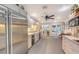 Open kitchen features stainless fridge, recessed lighting, and an adjacent dining area that leads out to a screened lanai at 4511 Windsor Park, Sarasota, FL 34235