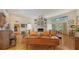 Spacious living room with hardwood floors, a fireplace, and ample natural light from large windows at 4511 Windsor Park, Sarasota, FL 34235