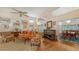 Bright living room with hardwood floors, a fireplace, and ample natural light from large windows at 4511 Windsor Park, Sarasota, FL 34235