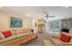 A cozy living room featuring a comfortable sofa, plush armchairs, and sliding glass doors leading to the pool at 4511 Windsor Park, Sarasota, FL 34235