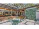 Outdoor patio area with an open-air shower and comfortable seating, ideal for relaxation and entertainment at 4511 Windsor Park, Sarasota, FL 34235