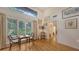 Charming sitting area featuring a table, chairs, wood floors, and natural light at 4511 Windsor Park, Sarasota, FL 34235
