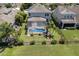 An aerial view shows a screened in pool, solar panels and a well manicured lawn at 4617 Garden Arbor Way, Bradenton, FL 34203