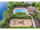 Aerial view of the community pool, clubhouse, playground, and lake showcasing the neighborhood's amenities at 4617 Garden Arbor Way, Bradenton, FL 34203