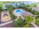 Aerial view of the community showcasing pool, playground, clubhouse, and lush landscaping at 4617 Garden Arbor Way, Bradenton, FL 34203