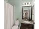 Bathroom features a double vanity with granite countertop, framed mirror and shower with glass doors at 4617 Garden Arbor Way, Bradenton, FL 34203