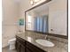 Bathroom featuring a granite countertop, large framed mirror, and a shower/tub combo at 4617 Garden Arbor Way, Bradenton, FL 34203