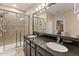 Modern bathroom featuring a double sink vanity, a glass-enclosed shower, and neutral décor at 4617 Garden Arbor Way, Bradenton, FL 34203