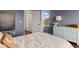 Comfortable bedroom featuring blue walls, a cozy bed, and ample storage space at 4617 Garden Arbor Way, Bradenton, FL 34203