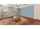 Bright bedroom featuring wood floors, natural light from large windows, and a decorative rug at 4617 Garden Arbor Way, Bradenton, FL 34203