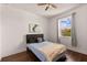 Bright bedroom featuring a comfortable bed, hardwood floors, and a sunlit window with a view at 4617 Garden Arbor Way, Bradenton, FL 34203
