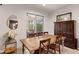 Dining area with natural light and view to the screened patio with outdoor furniture at 4617 Garden Arbor Way, Bradenton, FL 34203