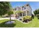 Charming two-story home featuring a well-manicured lawn, palm trees, and a two-car garage at 4617 Garden Arbor Way, Bradenton, FL 34203