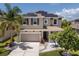 Two-story home featuring an attached garage, well-manicured landscaping, and solar panels at 4617 Garden Arbor Way, Bradenton, FL 34203