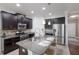 Modern kitchen featuring granite countertops, stainless steel appliances, and dark cabinets at 4617 Garden Arbor Way, Bradenton, FL 34203