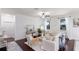 Bright living room with neutral decor, wood floors, and large windows overlooking the backyard at 4617 Garden Arbor Way, Bradenton, FL 34203