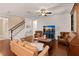 Inviting living room with hardwood floors, leather seating, and a stylish entertainment center at 4617 Garden Arbor Way, Bradenton, FL 34203